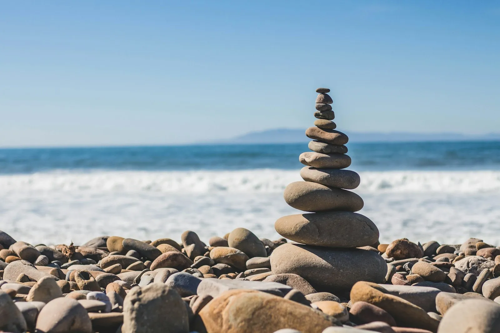 Smooth stones on a calm shoreline at first light