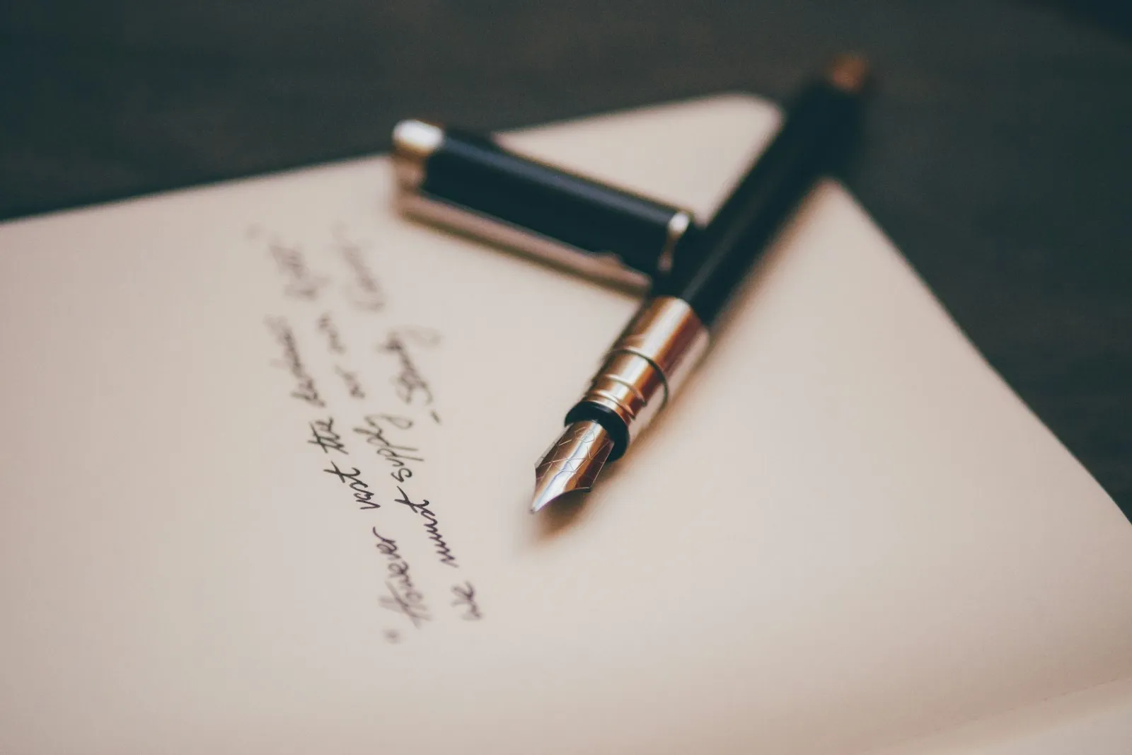 A fountain pen resting on a desk A fountain pen resting on a desk