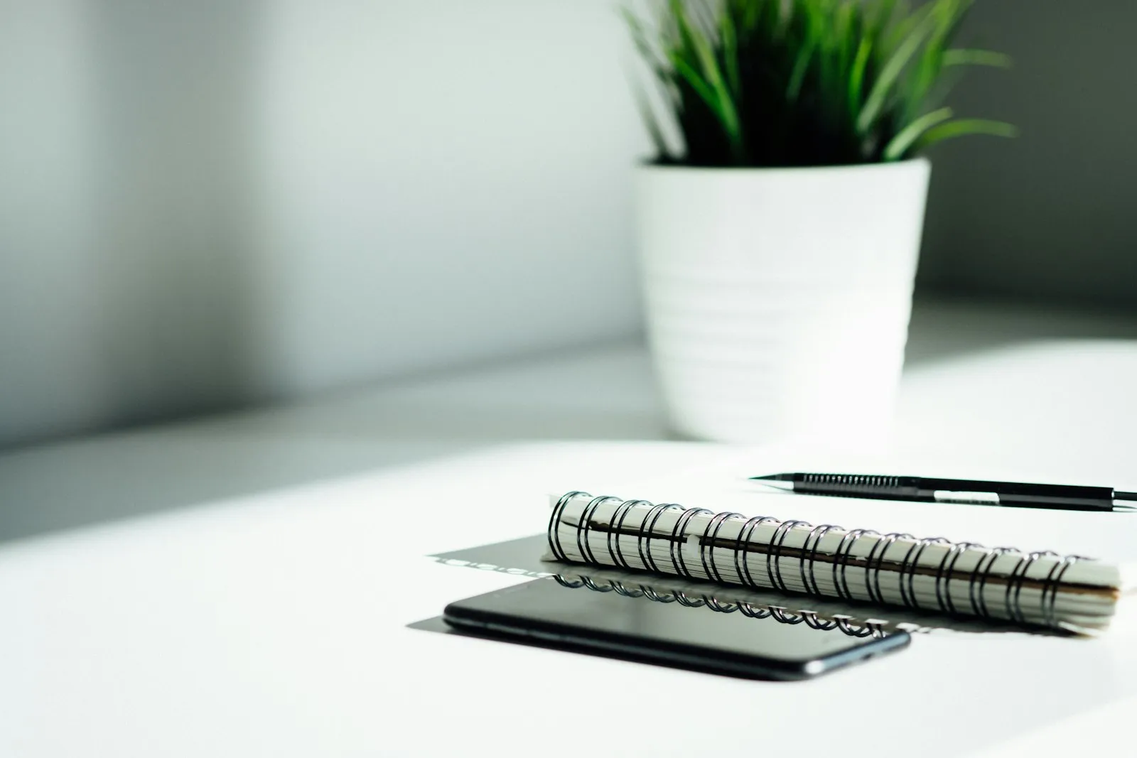 A pen and notebook laid out on a table A pen and notebook laid out on a table