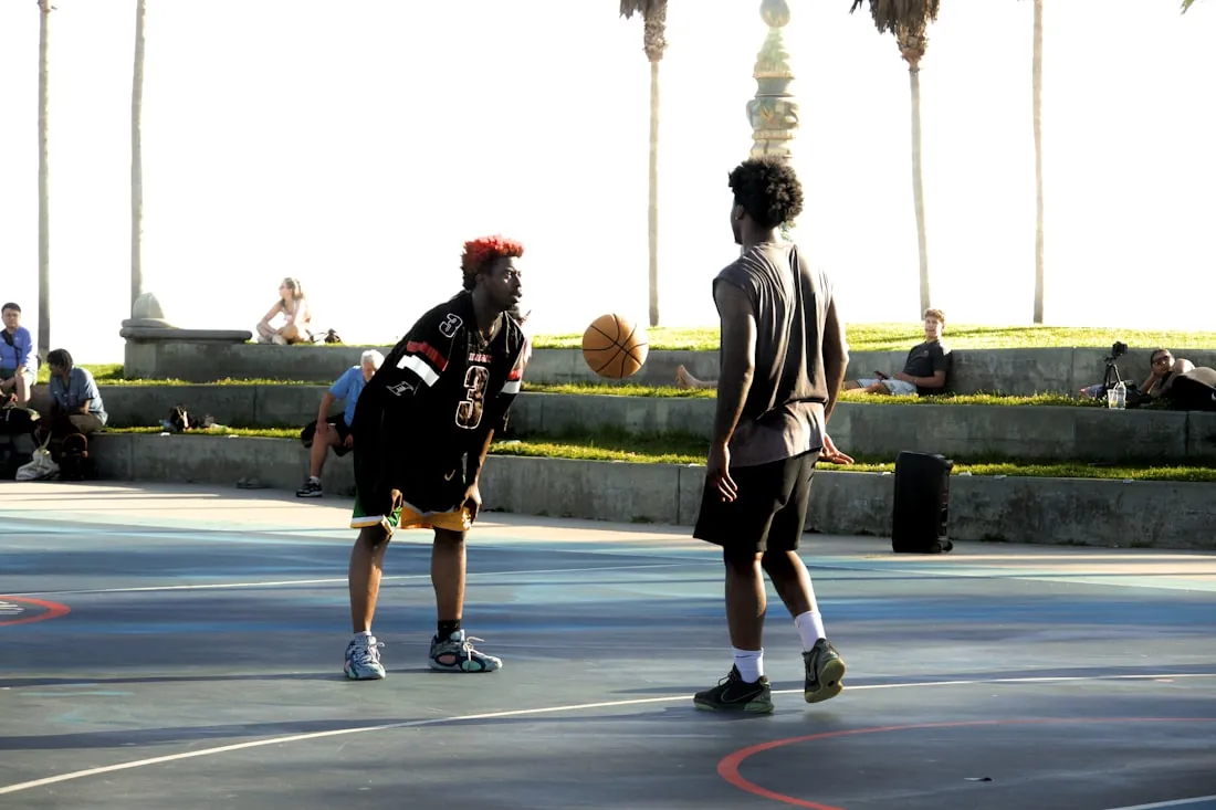 Basketball players mid-game at a community tournament Basketball players mid-game at a community tournament