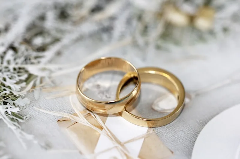 Two wedding bands resting on linen Two wedding bands resting on linen